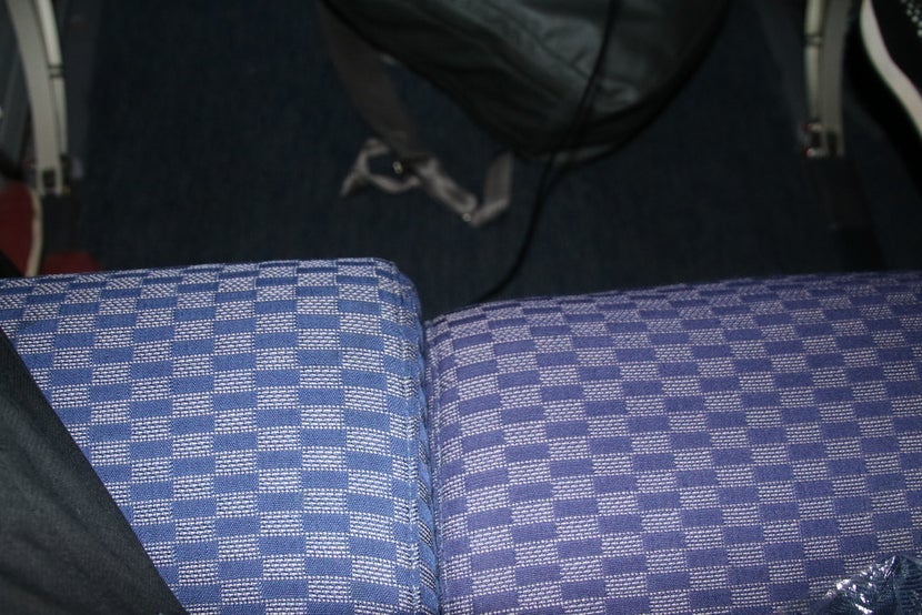 Window seat on left with full recline vs. middle seat with no recline