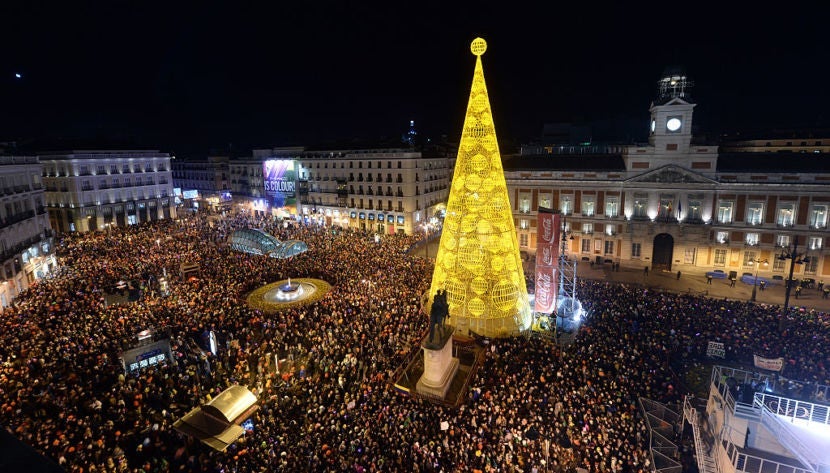 Thousands of people eating grapes on New Year's Eve in Madrid's Puerta del Sol plaza. Photo courtesy of Anadolu Agency via Getty.