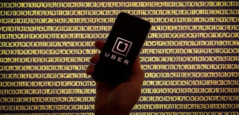 The ride sharing app Uber is seen on a smartphone in front of a binary background, in Bydgoszcz, on August 7, 2016. (Photo by Jaap Arriens/NurPhoto via Getty Images)