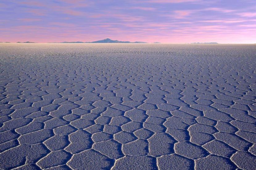 The Salar de Uyuni salt flats are an appetizing sight at sunrise. Image courtesy of Sergio Pessolano via Getty.
