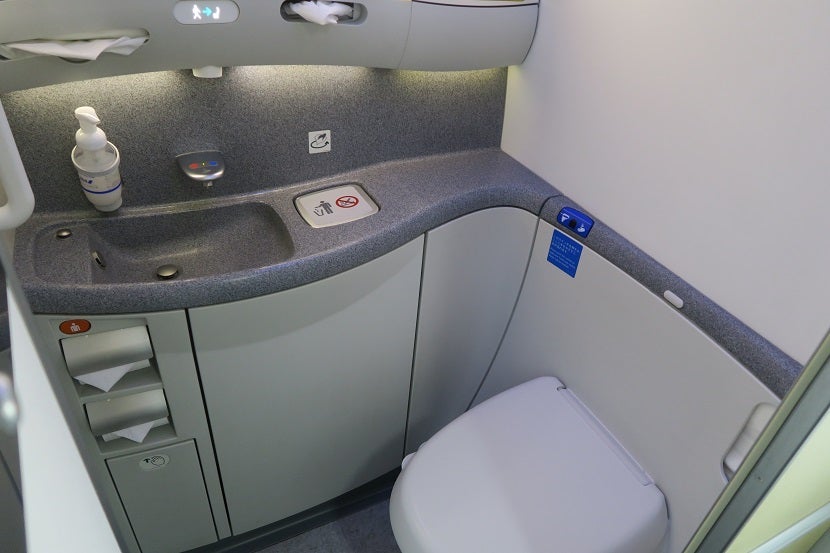 The toilet on the left side in the back of economy is the only bathroom without a bidet.