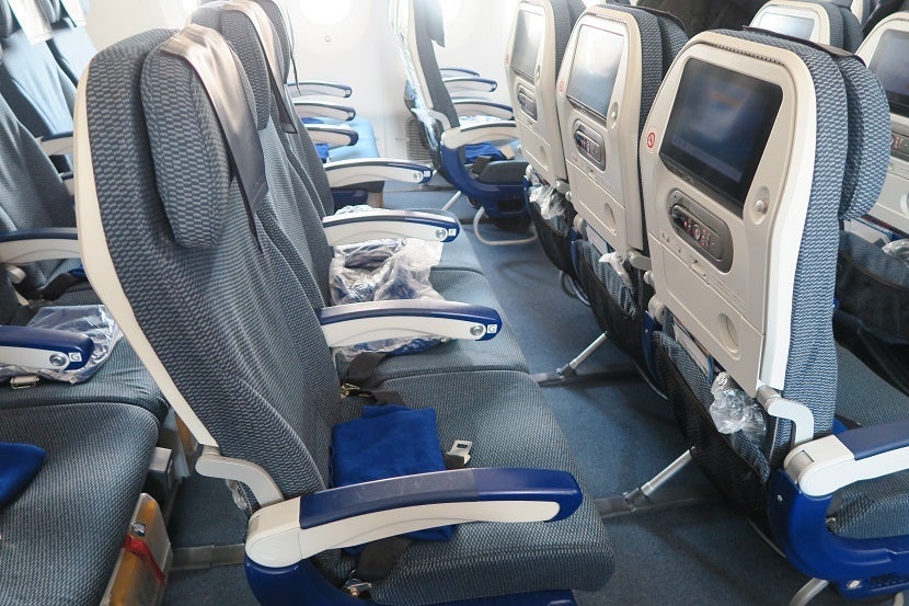 The seats are arranged into 3x three-seat rows on this version of ANA's 787-8 Dreamliner.