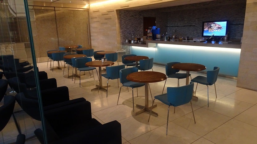 Cocktail tables and chairs await you next to the bar.