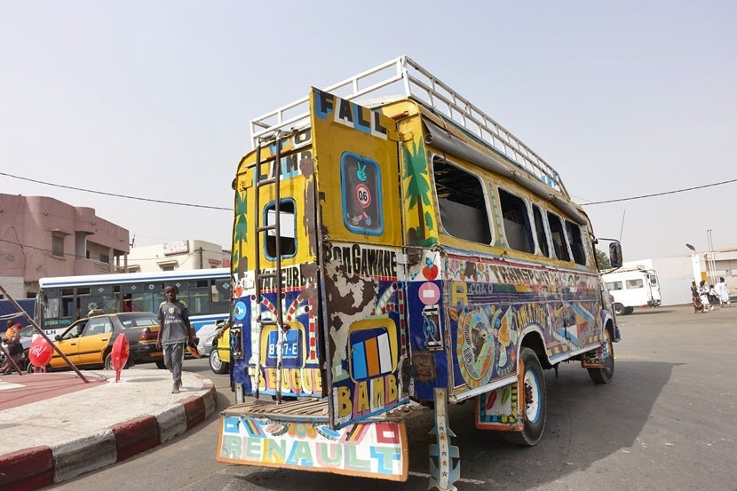 A typical bus in Dakar. Don't be alarmed to see more people that you could ever imagine fitting inside pouring out of one. Image by the author.