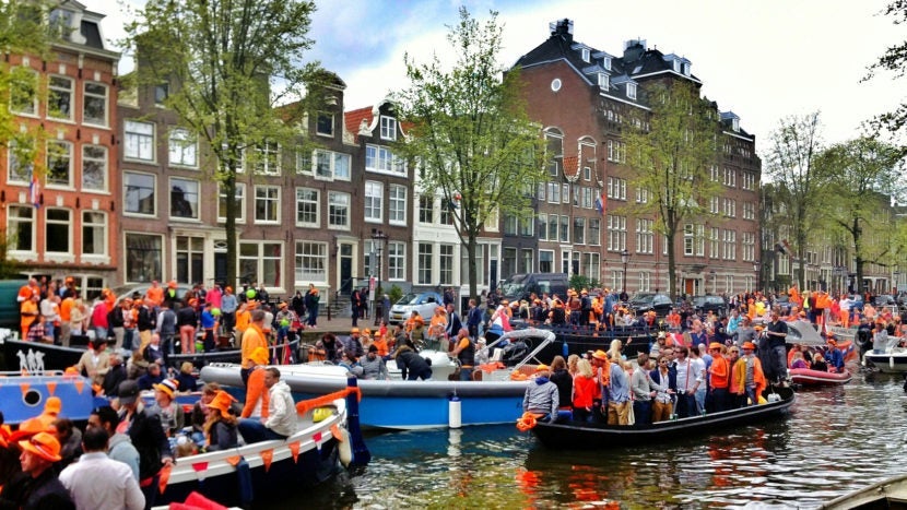 In Amsterdam, the Konigsdag parades go down canals, not streets. Image courtesy of Tobias Poel / EyeEm via Getty Images.