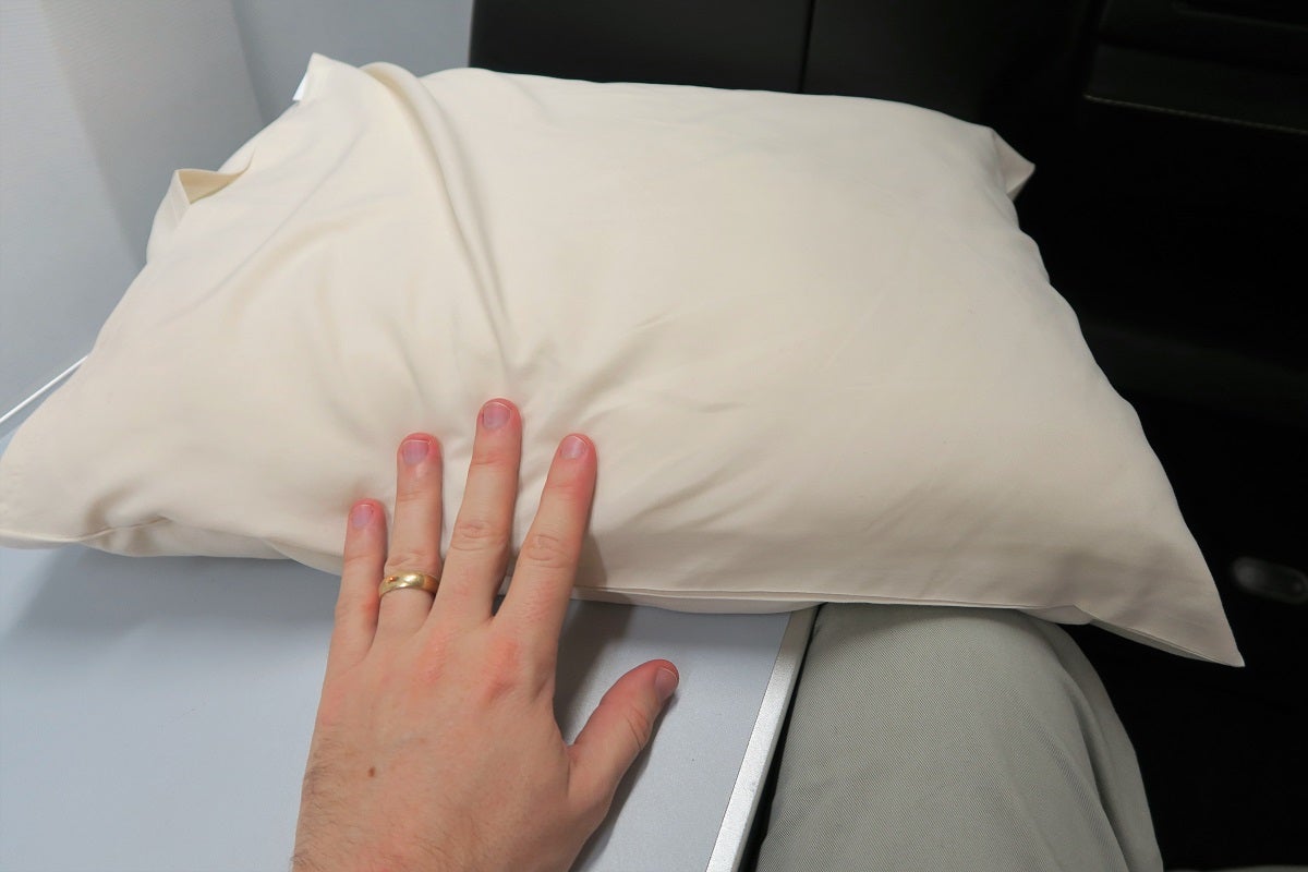 Full-size pillows — as you can tell by the comparison with my "very normal sized" hand — were left at each seat.