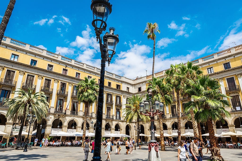 Escape Las Ramblas and duck into the nearby Plaça Reial for a breather. Image courtesy of Andia via Getty Images.