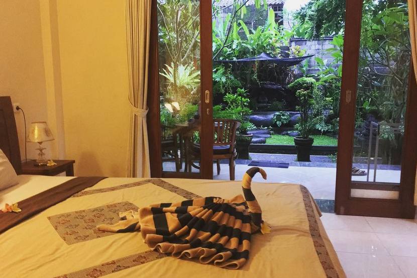 I stayed in this roomy private bungalow in Bali with breakfast and daily towel origami for $19 a night. Image by the author.