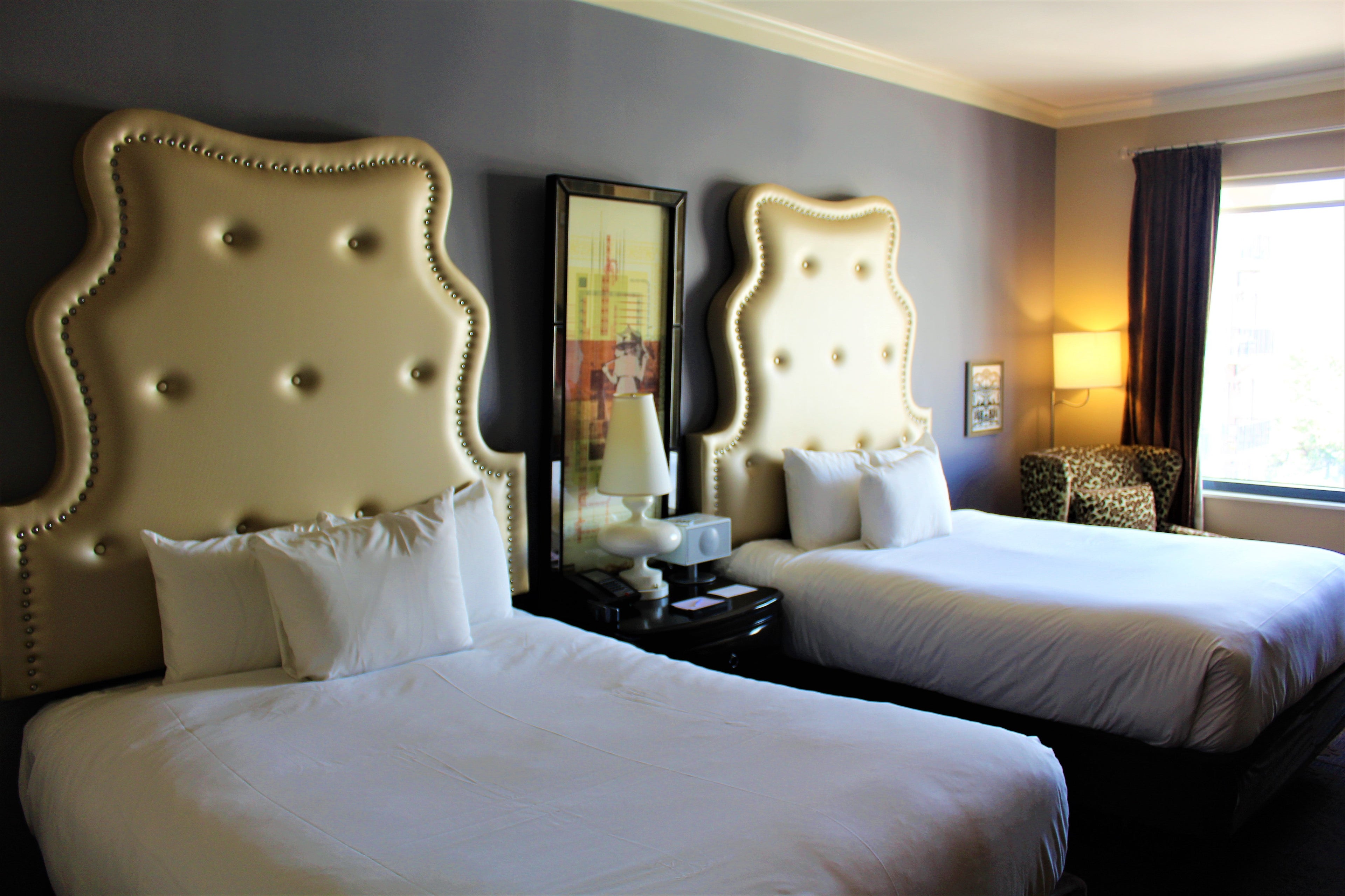 Two queen beds with chic headboards added to the room's modern feel.