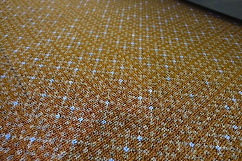 You'll see recycled uniforms in the carpeting.