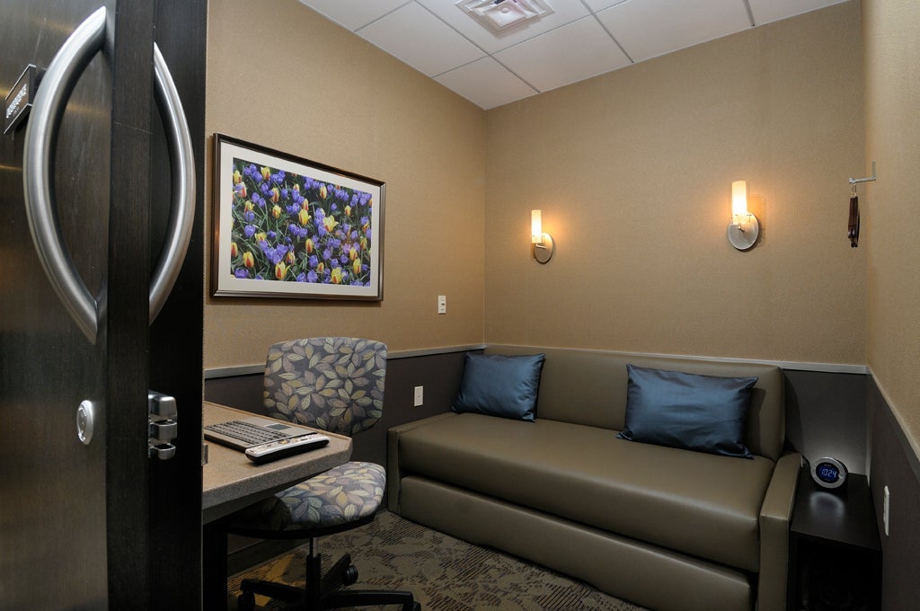 A minute suites room, showing a sofa and workstation