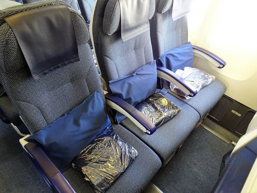 Pillows and blankets await you in Economy.