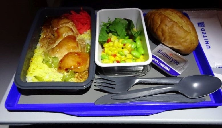 Chicken teriyaki with salad and a roll.