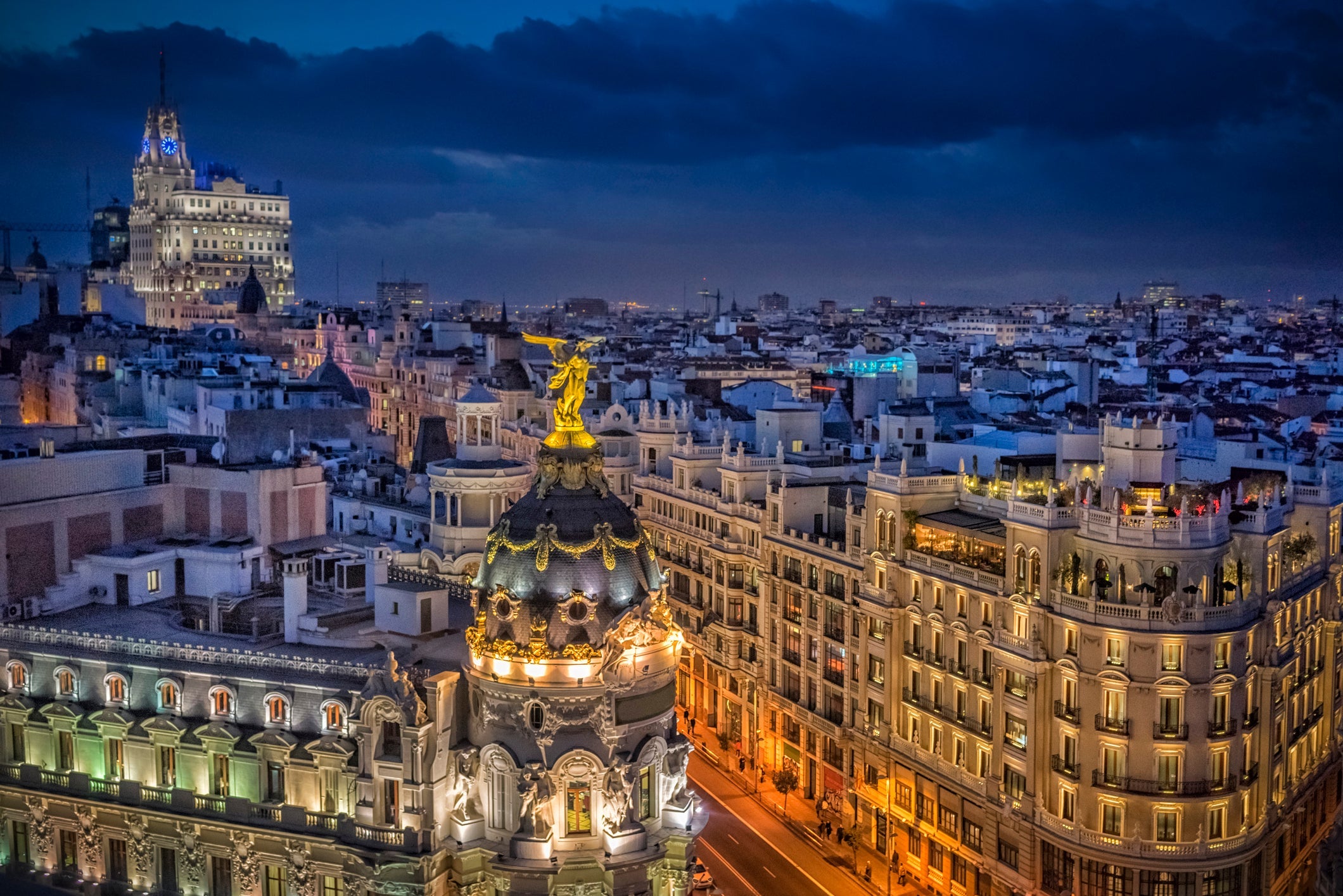 Buildings of La Gran Vía de Madrid at night with the lighting and beauty of its streets. Panoramic view of the rooftops and streets of Madrid