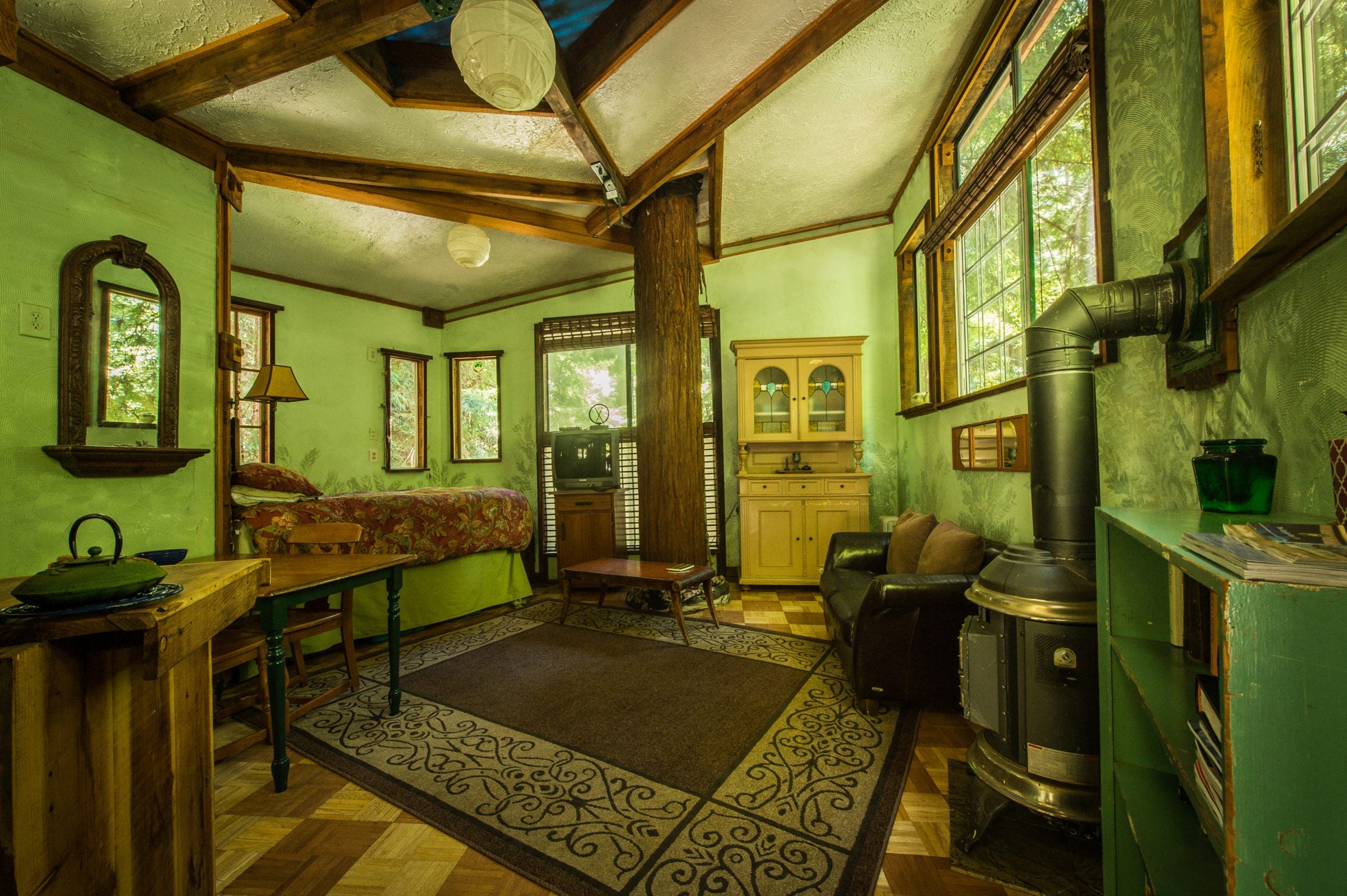 A wood burning stove keeps the tree house cozy on chilly evenings. Photo courtesy of Glamping Hub.