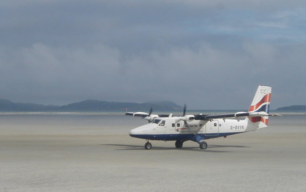 Planes land on the beach runway at Barra Airport. Image by Sue Jackson / Wikipedia Commons.