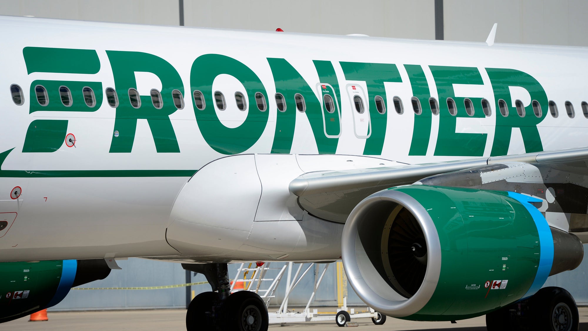 Frontier employees and executives physically pull a 46-ton Airbus A320 out of the Frontier Airlines hanger at Denver International Airport in Denver.