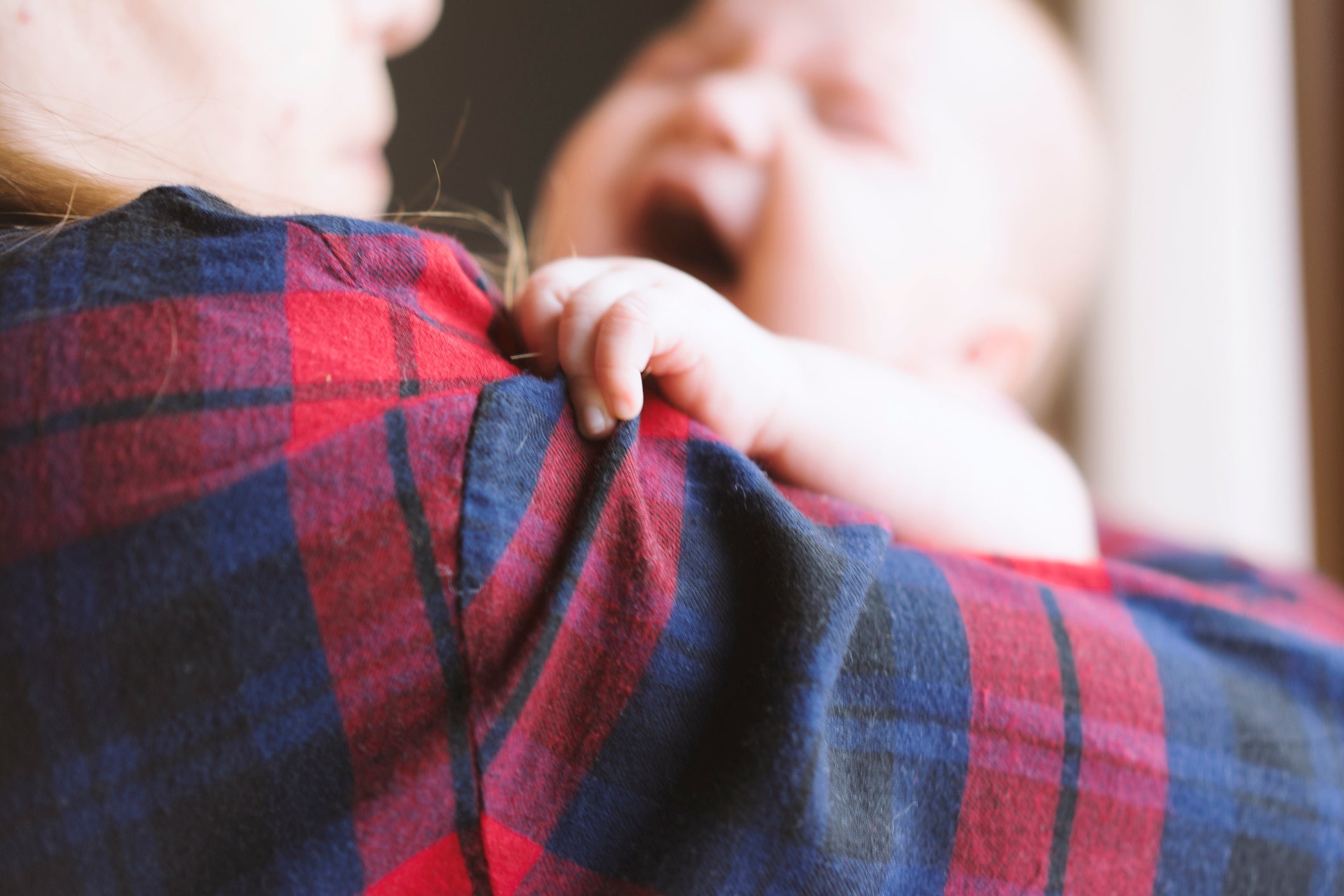 Newborn baby in her mother's arms