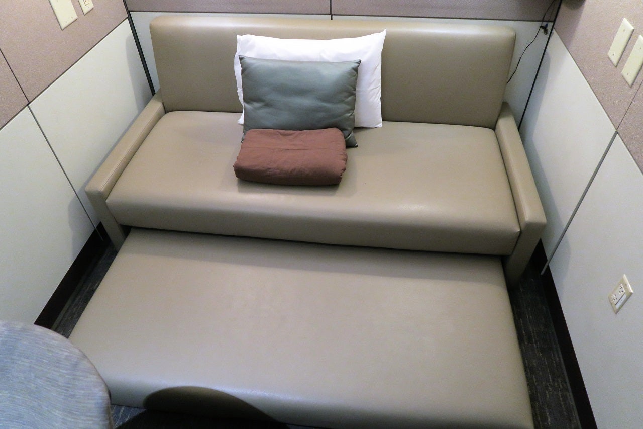 pulling out the extension under a sofa to make a larger bed