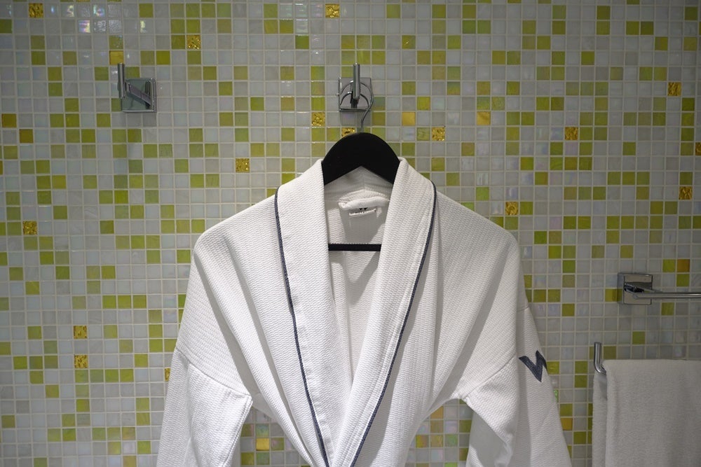 The other robe hung in the bathroom.