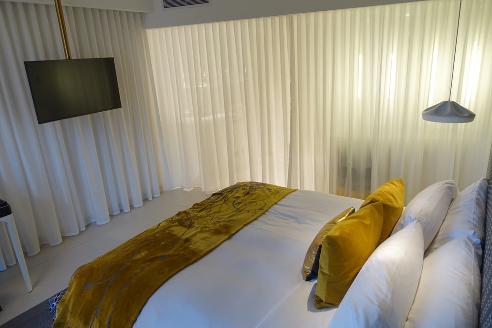 You could close the bedroom off from the bathroom with a curtain, but it didn't soundproof anything.