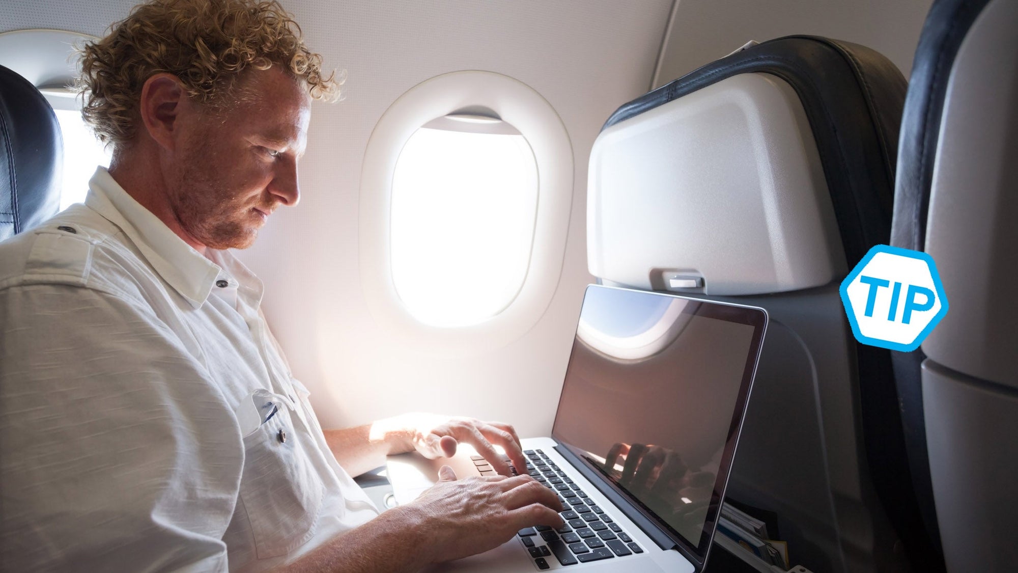 Adult man using laptop on the plane