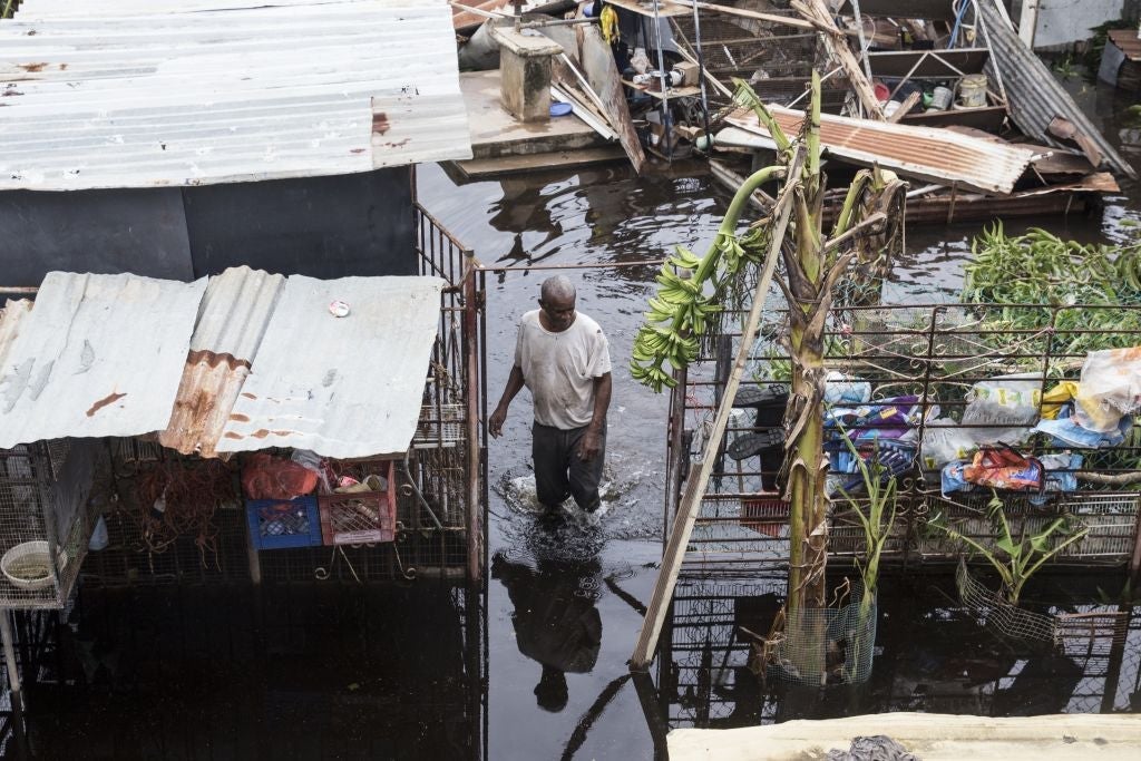 LOIZA, PUERTO RICO - SEPTEMBER 22: A resident wades through flood water days after Hurricane Maria made landfall, on September 22, 2017 in Loiza, Puerto Rico. Many on the island have lost power, running water, and cell phone service after Hurricane Maria, a category 4 hurricane, passed through. (Photo by Alex Wroblewski/Getty Images)