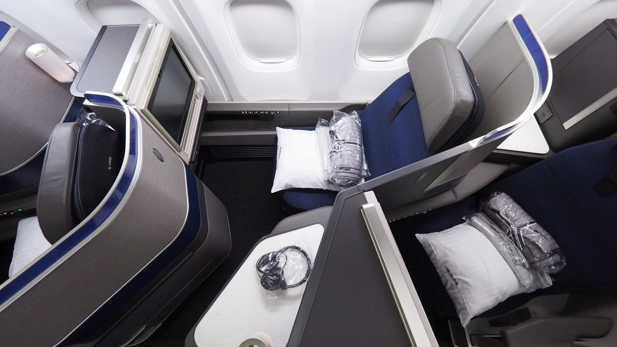 United Polaris business class -- blue 767 seats, a side console and a window