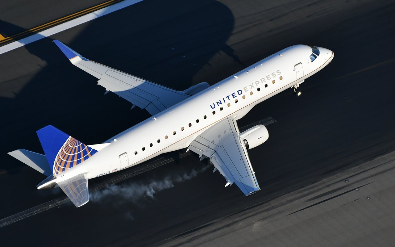 An Embrarer 175 regional jet burns some rubber on landing