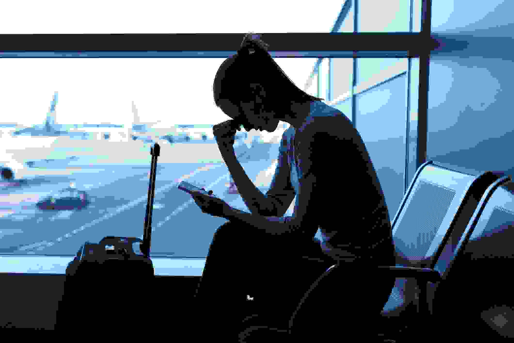 Stressed, tired or ill woman at the airport