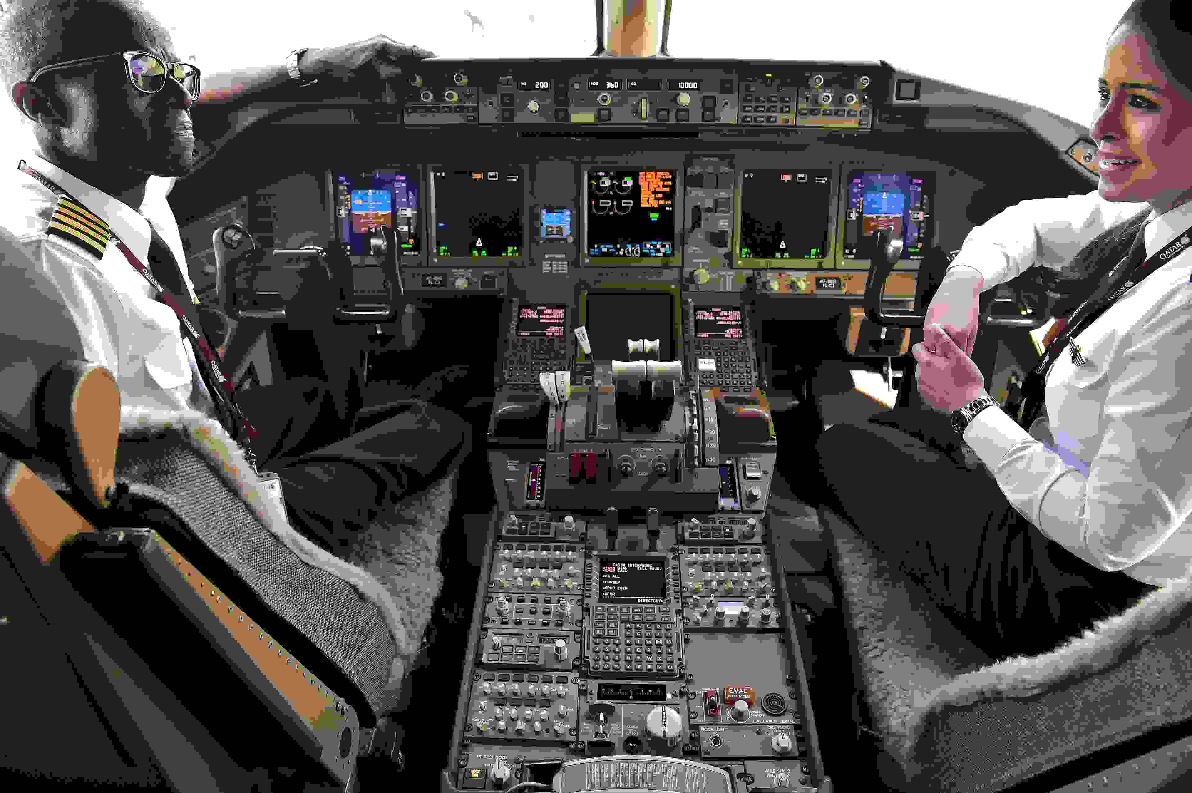 Qatar Airways pilots chat in the cockpit of a Boeing 777 jet airliner on display at the International Paris Air Show in Le Bourget outside Paris on June 22, 2017. (Photo by Christophe Archambault / AFP / Getty Images)