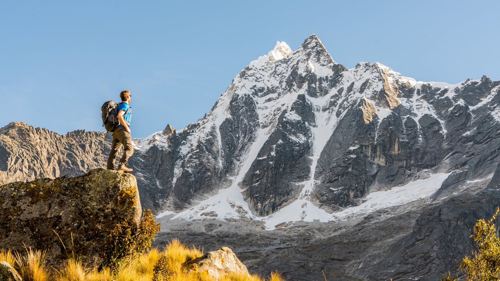 Low Angle View Of Person Standing On Rock Against Sky