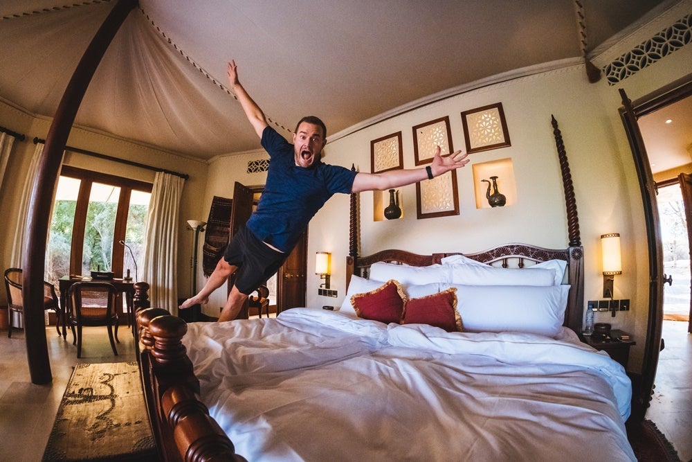 Brian Kelly jumping on bed at Al Maha