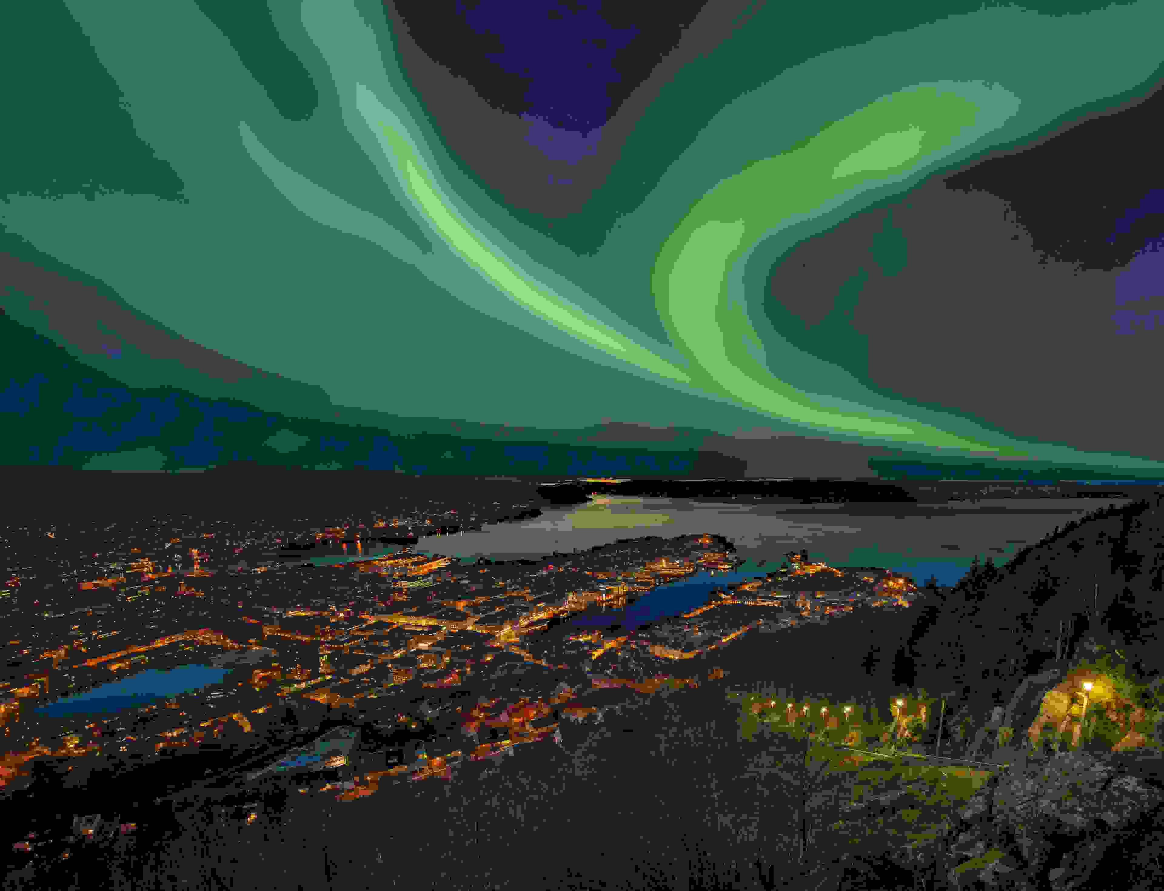 The Northern Lights over harbor of Bergen City, Norway. Image by RelaxFoto.de / Getty Image.
