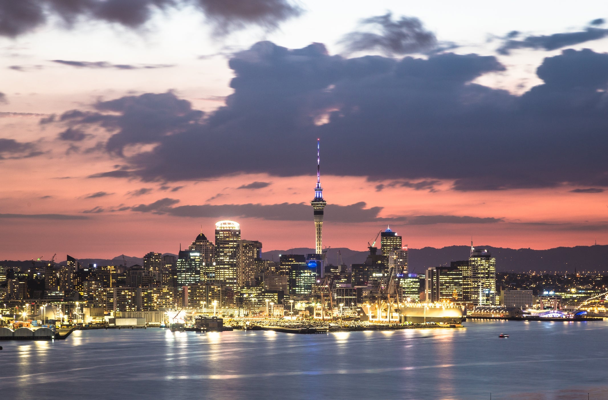 Stunning sunset over the Auckland financial district famous skyline from the viewpoint in Davenport in New Zealand