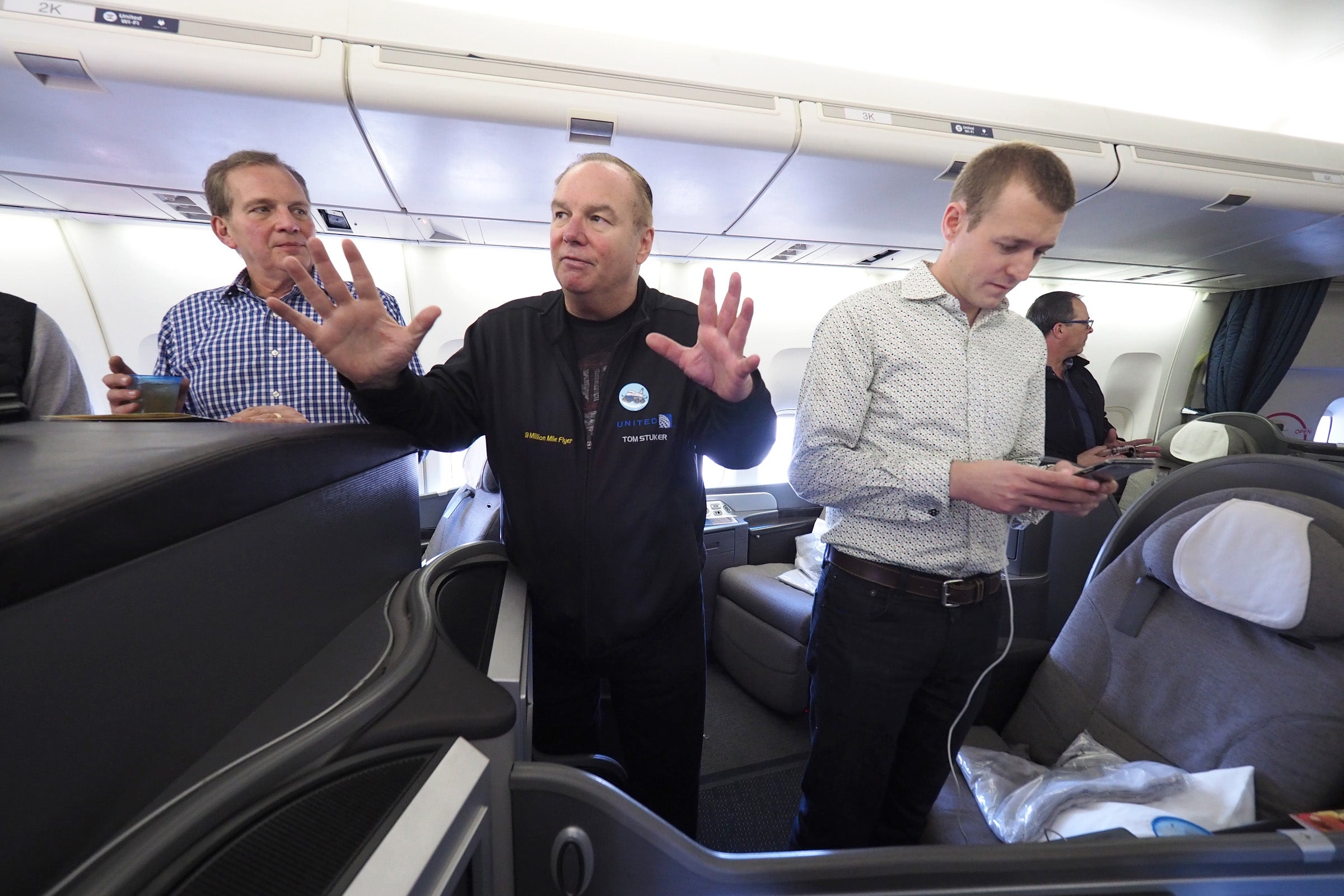 Tom chats with first-class passengers on United Flight 747.