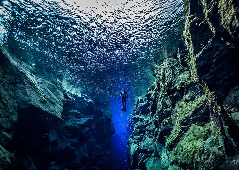 Snorkeling between the tectonic plates at Silfra. Image credit: Getty Images.