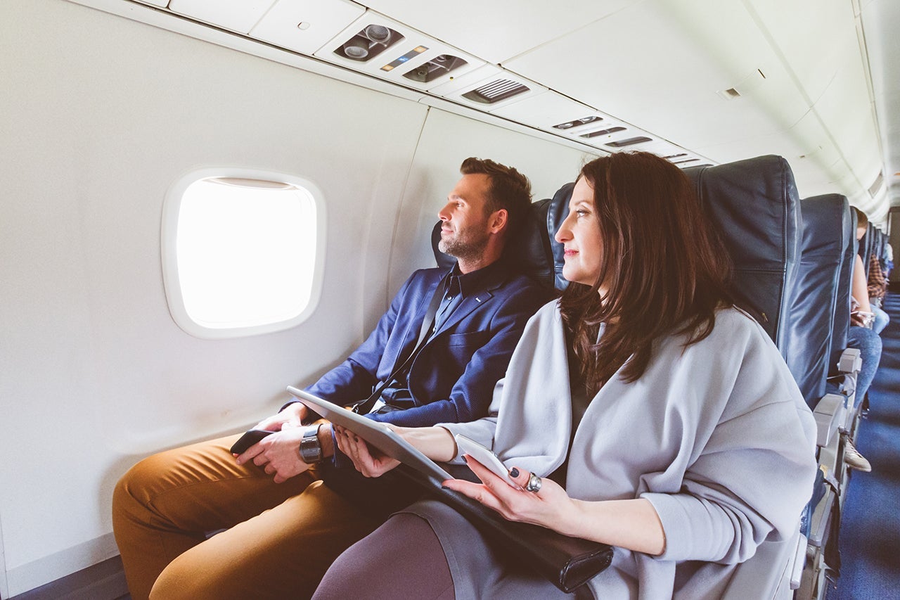 Couple sits together on a plane