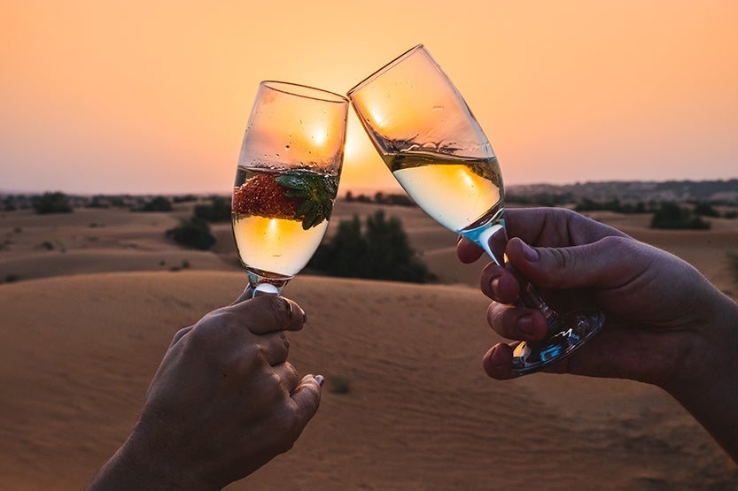 Desert sunset champagne Al Maha Desert Resort Dubai Review