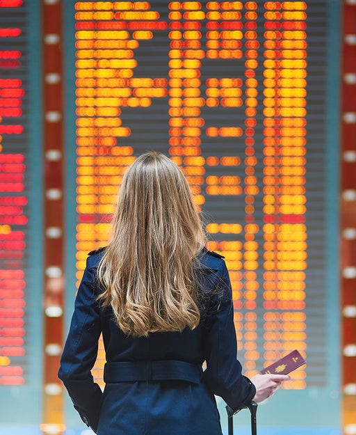 Woman in terminal in front of schedule