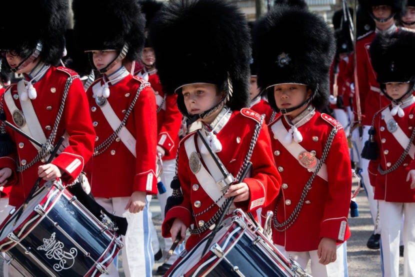 COPENHAGEN, DENMARK - APRIL 09: The Tivoli Guard are seen marching through the Tivoli Garden during the first Sunday of the new season on April 9, 2017 in Copenhagen, Denmark. The Tivoli Guard, once male only, have 90 members for children 8 to 16 years of age and now include 9 girls. The guard itself goes back to the year after the amusement park was established in 1843 in the very center of Copenhagen. (Photo by Ole Jensen - Corbis/Corbis via Getty Images)
