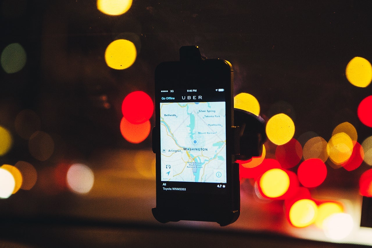 The Uber driver app on the windshield of former Washington Flyer taxi driver Ali Jaghori. Jaghori now drives soley for UberX. Thousands of local car owners have signed up in recent months to drive with one of the "ride-share" operators that use smartphone apps to link people needing rides with car owners willing to give them, for a price. Photo by Evelyn Hockstein/For The Washington Post via Getty Images