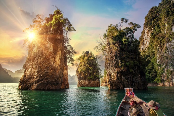 Tour operators lead trips to beautiful destinations like Cheow Lan Lake in Suratthani, Thailand. Image by Thatree Thitivongvaroon/Getty Images