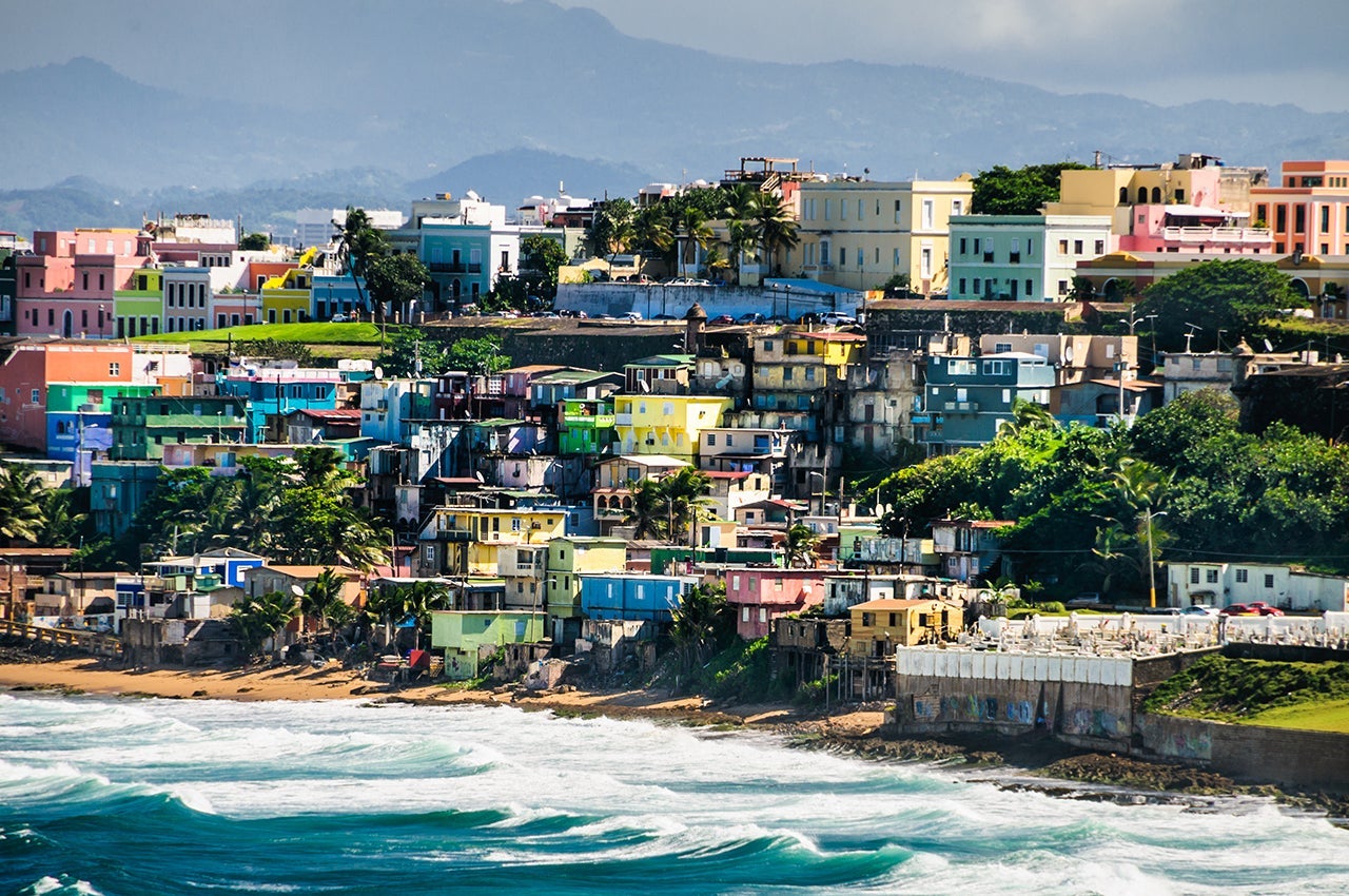 Bright, pastel colors of houses in a neighborhood of San Juan, Puerto Rico. Photo by Ken Wiedemann / Getty Images