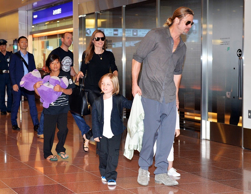 US film stars Brad Pitt (R) and Angelina Jolie (back C), accompanied by their children, arrive at Haneda International Airport in Tokyo on July 28, 2013. Pitt is now here for the promotion of his latest movie "World War Z". AFP PHOTO / Yoshikazu TSUNO (Photo credit should read YOSHIKAZU TSUNO/AFP/Getty Images)