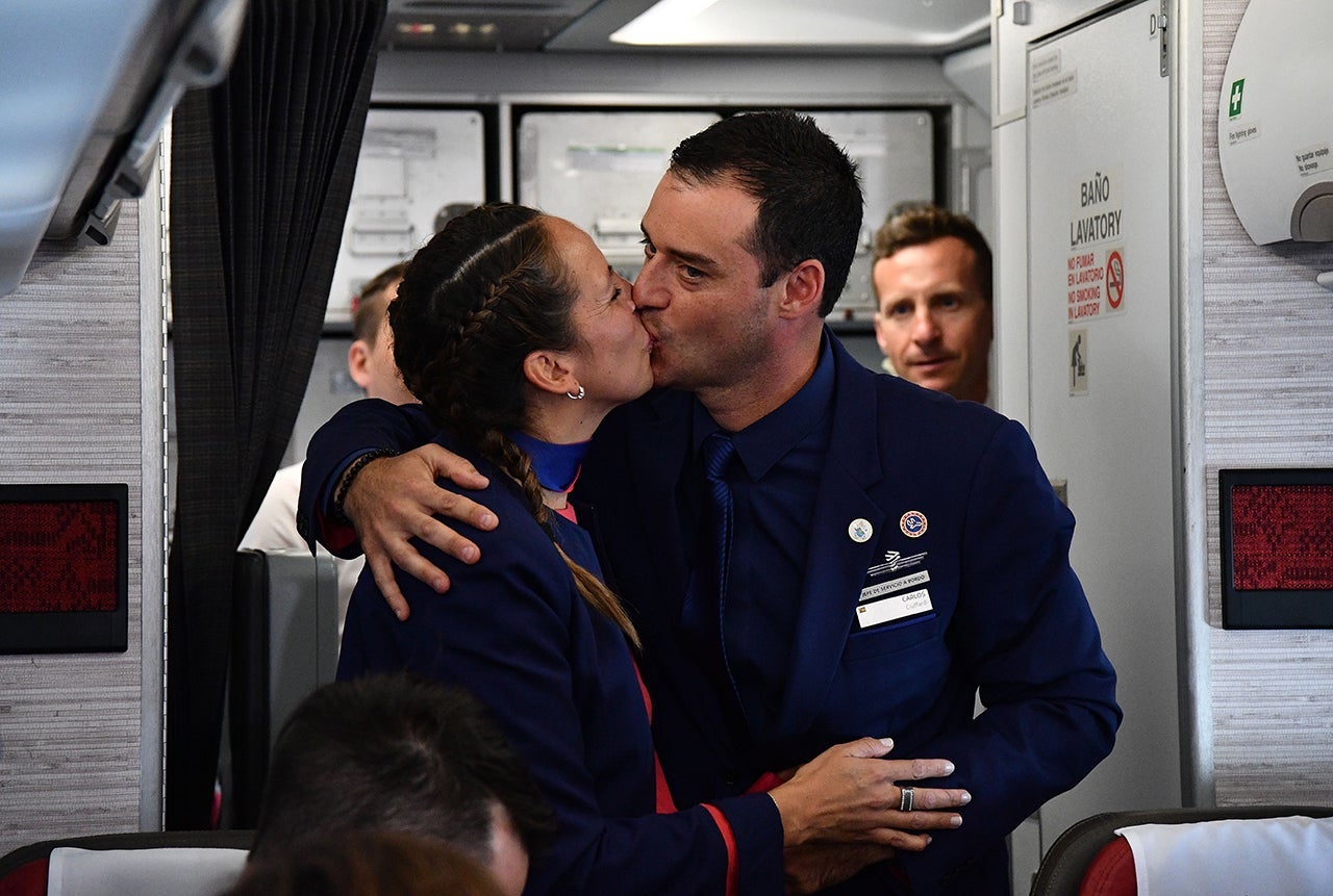 Crew members Paula Podest and Carlos Ciuffardi kiss after being married by Pope Francis during the flight between Santiago and the northern city of Iquique on January 18, 2018.Pope Francis married the couple during the flight to Iquique where he will celebrate an open-air mass on the beach before leaving for Peru on the last leg of his South American trip. / AFP PHOTO / POOL / Vincenzo PINTO (Photo credit should read VINCENZO PINTO/AFP/Getty Images)