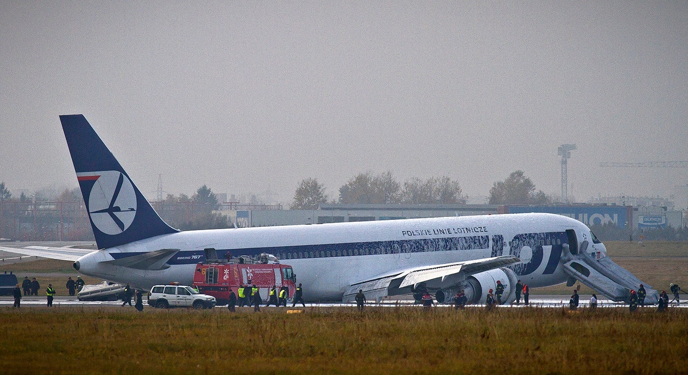 Fire engines and emergency vehicles surround a LOT Polish airlines Boeing 767 after it made an emergency landing at Warsaw's airport on November 1, 2011, without its landing gear. (Photo by Wojtek Radwanski/AFP/Getty Images)