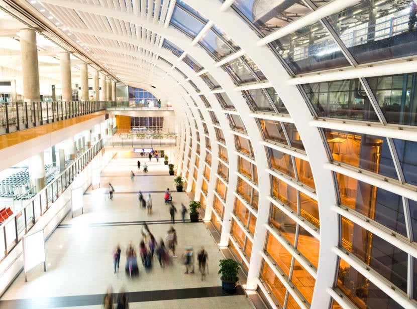 Group of people running on hong kong airport. Photo by Baona// Getty Images