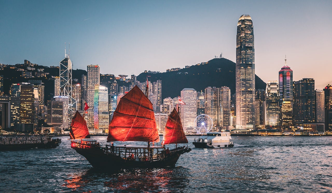 Traditional junk boat sailing across Victoria Harbor, Hong Kong. (Photo by Yongyuan Dai/Getty Images)