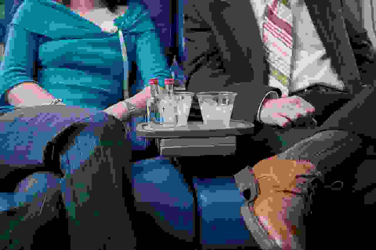 Sharing a drink with the person sitting next to you. (Photo by ColorBlind Images/Getty Images)